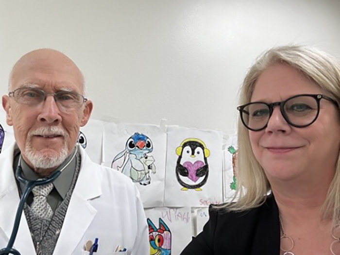From left, Dr. Wendell Weston Sumner with Pediatric Health Services and Tricia MacLaughlin, Sr. BCBSNM Provider Relations Representative. MacLaughlin visited Dr. Weston Sumner for a provider visit on Jan. 30. Pictures displayed in the background were colored by Dr. Sumner’s patients.